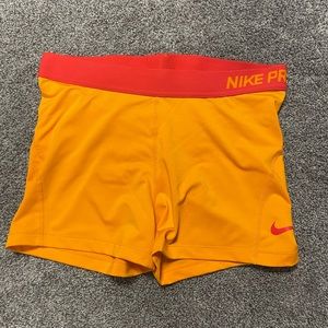 Nike Pro women’s large orange shorts with red waist band